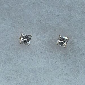 14K JCM CZ stud earrings.